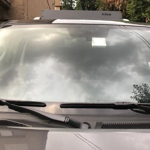 Aukey DR02 Dashcam installed next to rear view mirror mount, passanger side. Barely visible.
