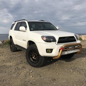 Two months later after purchase. Black, bronze theme with red highlights slowly being applied: black headlights, front grill plastidipped, yellow fogs