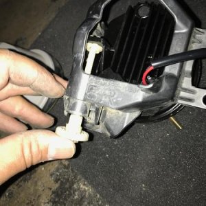 Pushing back and securing the alignment screw when attaching old mounting bracket to the Morimoto fog lights.