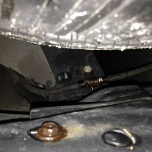 This is front pass side wheel well showing re-routed A/C drain line directing water drainage away from top of frame to the area pictured so drain wate