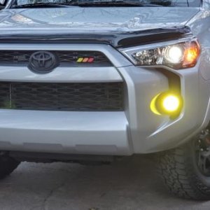 AVS bug deflector, yellow fog tint, Toyota tri-color badge, black toyota logo overlay, TRD 17" wheels with Falken Wildpeak 265/7017 tires