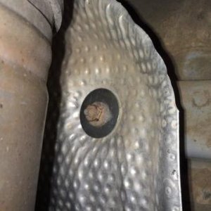 Muffler heat shield fixed with fender washers.