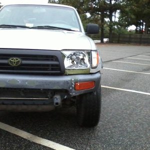 Front left (drivers' side) bumper dented inward.