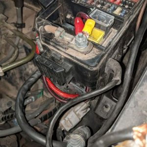 Wiring for the aux box and amp run through the firewall and the bottom of the fuse box - looks nice and clean when the box is put together.