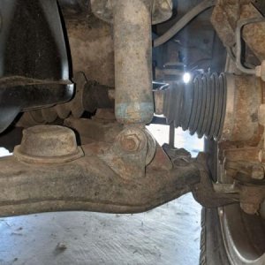 Driver's coilover bushing was completely shot. To the point where it would bounce up and down and make a horrendous "clunk" when going from a driveway