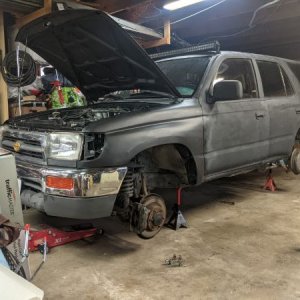 Up on jack stands to drop the tank.