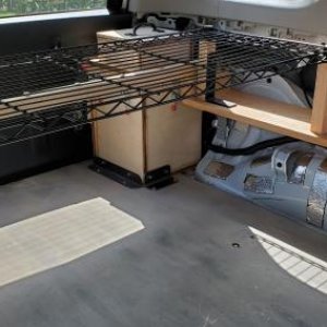4Runner shelf - driver's side. The propane locker is in the rear corner. Two 1 1/2" x 1 1/2" oak legs to support the black vinyl-coated wire shelf are