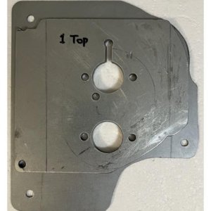Mounting plate with four spacers stacked on top, ready to install.