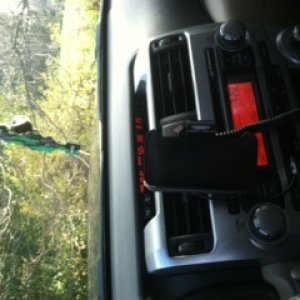 Semi-home made iphone mount that angles toward the driver or faces center, swings 360 for horizontal or vertical viewing, and allows for the charger t