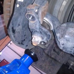 Lower ball joint detatched (floor jack beneath to prevent over-extention).
