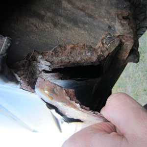 under the passenger side bumper