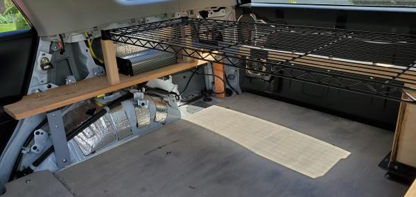 4Runner shelf - passenger side. Two oak legs support the black wire shelf, similar to the driver's side. A Giandel 1200W pure sine wave inverter is bo