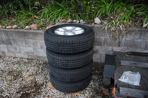 4x 265/70/17 Bridgestone Dueler H/T tires, stock wheels, caps and lugs