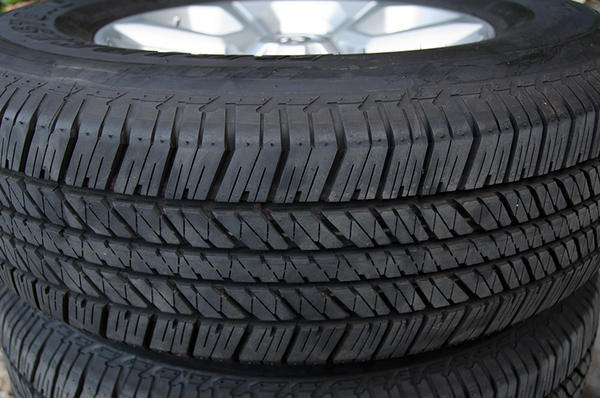 4x 265/70/17 Bridgestone Dueler H/T tires, stock wheels, caps and lugs