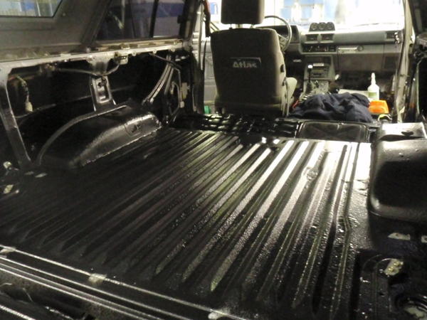 After I threw fiberglass on top of the patched areas, I scuffed and cleaned the whole floor, coated the patched areas and fender wells with POR-15, th