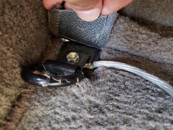 Amp grounded in back left corner under the carpet to the tie-down hook