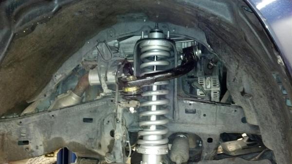 Another shot of the front coilover. Light racing upper control arm installed.