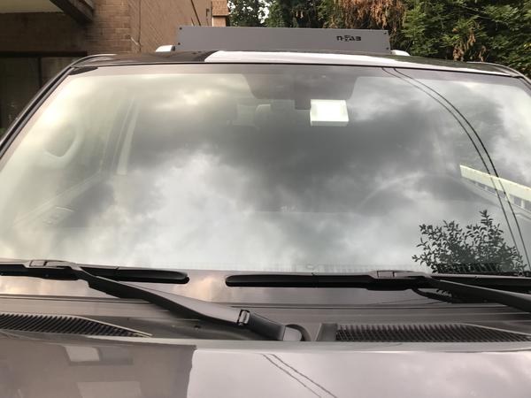 Aukey DR02 Dashcam installed next to rear view mirror mount, passanger side. Barely visible.