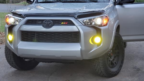 AVS bug deflector, yellow fog tint, Toyota tri-color badge, black toyota logo overlay, TRD 17" wheels with Falken Wildpeak 265/7017 tires