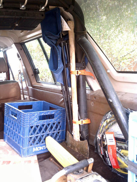 Axe and shovel (not shown) are attached to the roll cage using rubber "ski straps".  A camping chair is also attached but with velcro attachments inst