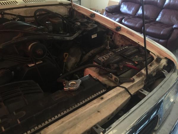 Battery/overflow relocation... And yes that's a couch in my garage :)