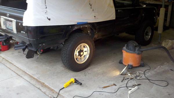 Beginning to grind out the rust from above the wheel well.