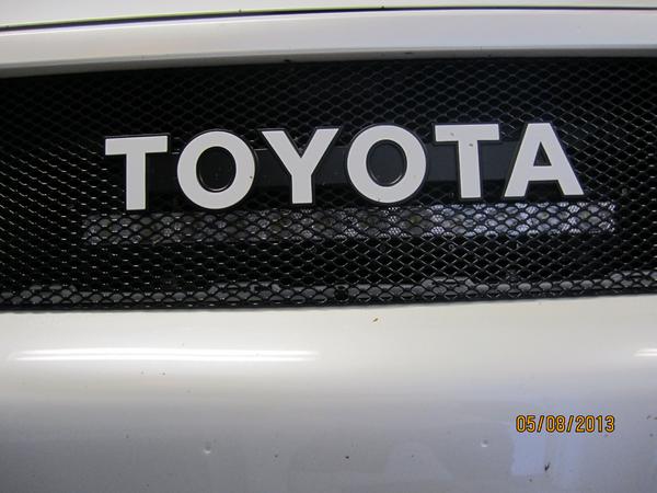 behind the logo light mount off. Trust me its level. Its the angle of the picture