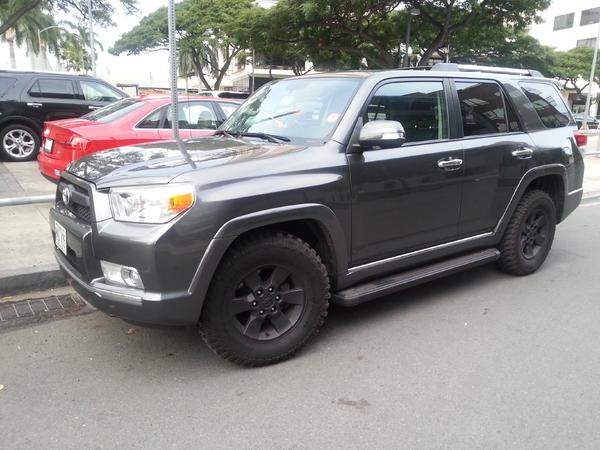 blacked out wheels, running boards, grill, and rack footings.