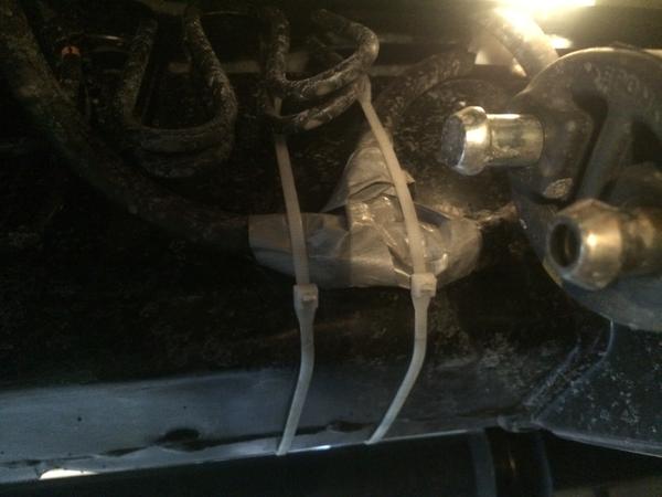 Breather tube junction from two to one underneath driver footwell
