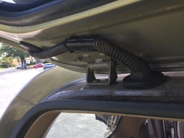 Cables ran up the inside of the rear hatch door, through the black rubber tube, into the overhead lining.