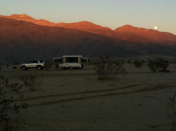 Camping with Coleman tent trailer under full moon