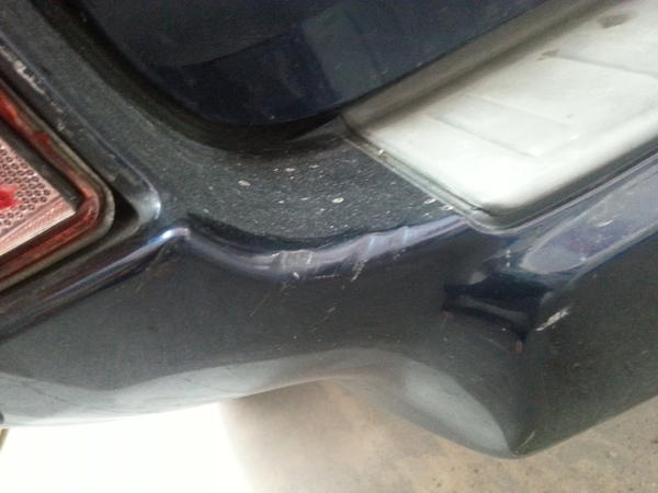 Close up of quarter panel and busted reflector.