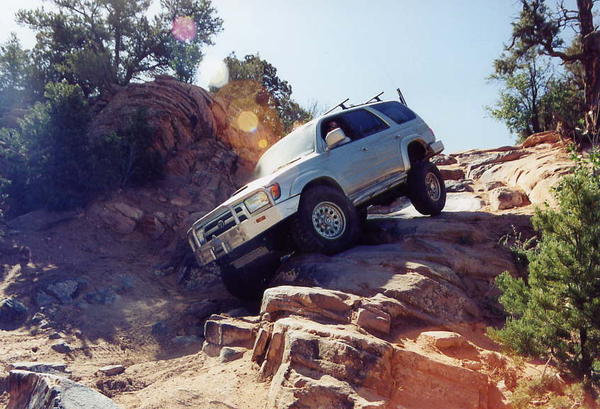 Coming down the fun line on the High Dive obstacle on the Behind the Rocks trail near Moab, Utah.