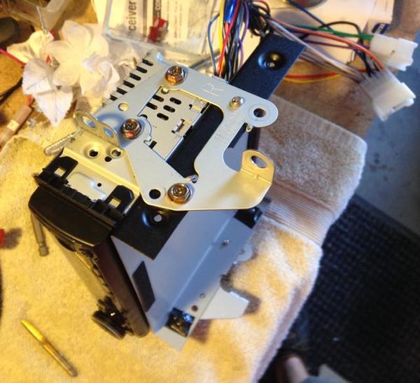 Drilled/tapped radio bracket to accept CB radio and use Toyota OEM bolts.