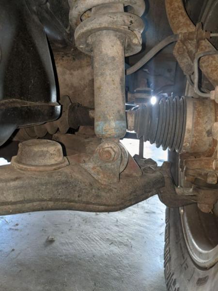 Driver's coilover bushing was completely shot. To the point where it would bounce up and down and make a horrendous "clunk" when going from a driveway