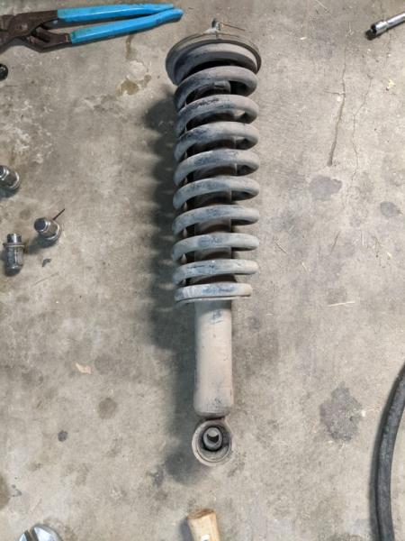 Driver's side coilover removed to replace the lower bushing.