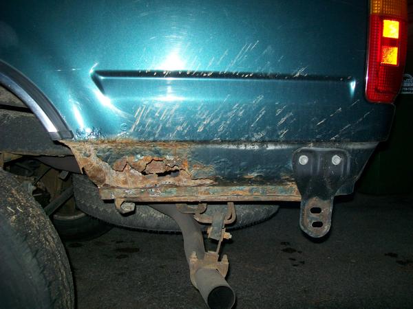 Drivers side rear corner.  All the way through.