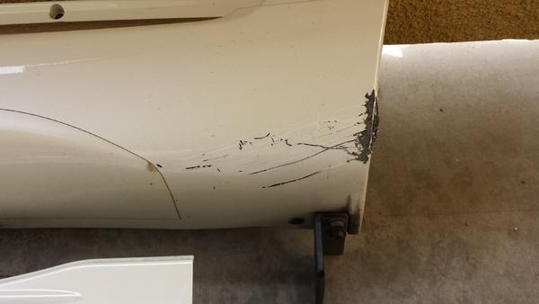 Driver's side rear.  This is some damage from a rock scrapping it.