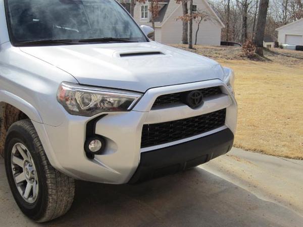 Emblem and lower bumper cover