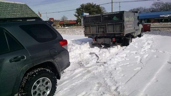 Extricating a plow truck with the grocery getter.