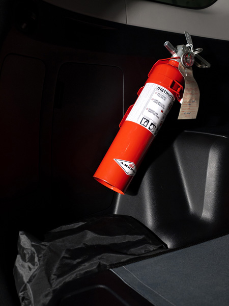 Fire Extinguisher with bracket secured to plastic interior on driver's side using well nuts