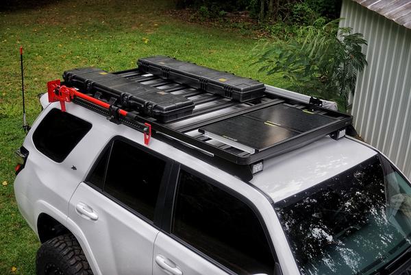 Front runner slimline II with dual cargo boxs, goal zero boulder30 solar panels, hi-lift jack, and Foxwing Awning 2.1