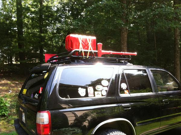 Gas tank, shovel, and axe on the roof rack.