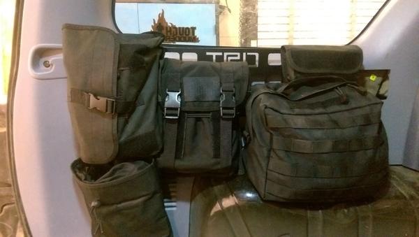 Here it is installed with the pouches attached. It holds my jumper cables, tow straps, bungee cords, and an entire tool kit. It freed up a lot of room