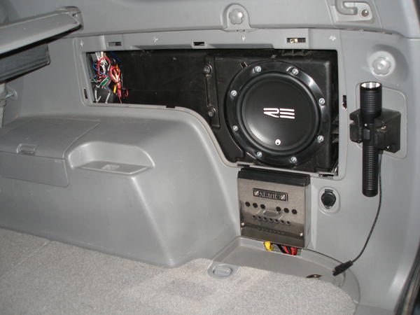 Here's my aftermarket sub - an RE 8", and Xtant 1.1i mono amp. Just reused the OEM housing and filled it with polyfill. This setup actually sounds sur