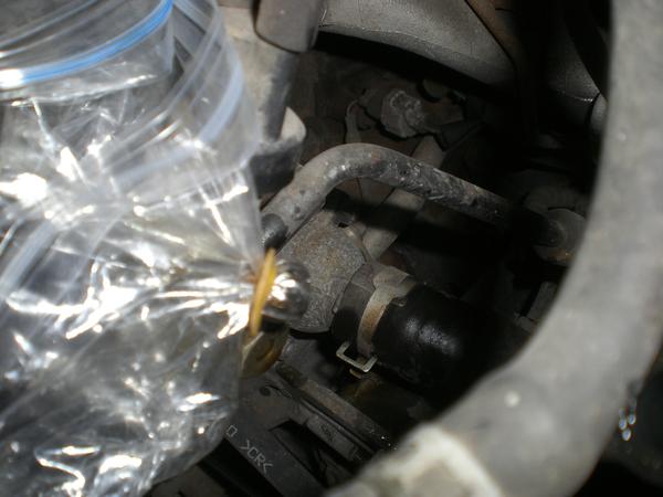I capped the 'return' line from the rack/pinion steering below so it would not drain out as I was setting up my work place.