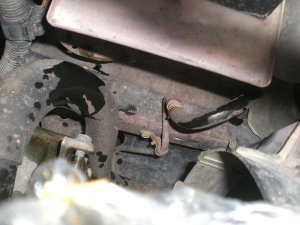 I pulled the hose from the reservoir and pushed it down next to the frame to drain as I turned the steering wheel from side to side.