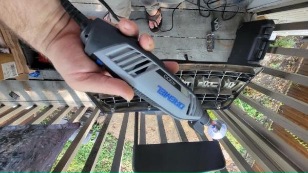 I used a Dremel, don't. Use a jigsaw.