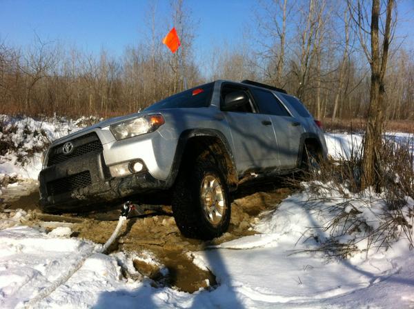 Ice covered hole. It did not look deep, but was. Result = Stuck. Did not have locker engaged. Exhaust was well under water