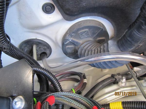 IM
Used a clear rubber water tube cut at a sharp angle to fish through the grommet into the passenger side foot well G 6224
